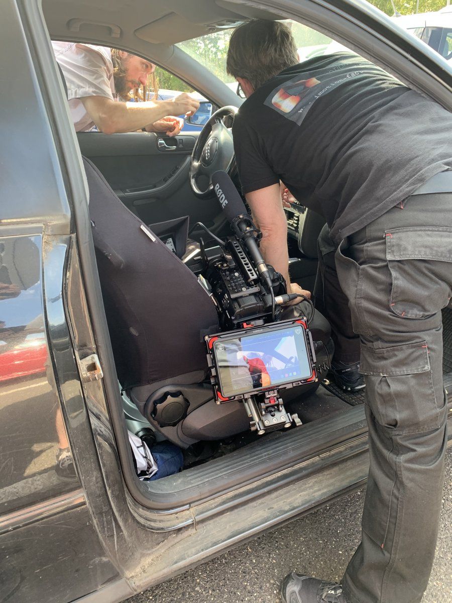 The parking ticket scene was done in no time. The cameraman films Mr. Gray from inside the car.